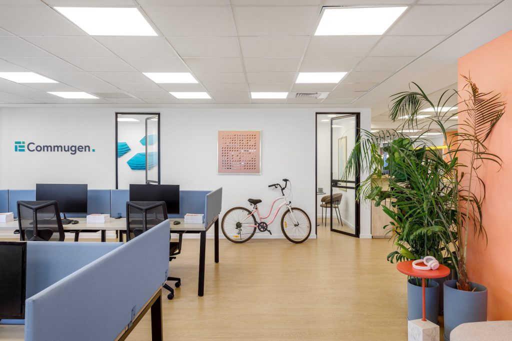 Workstations facing the logo wall and planters