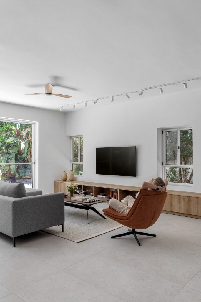 TV area with a leather armchair and a low coffee table