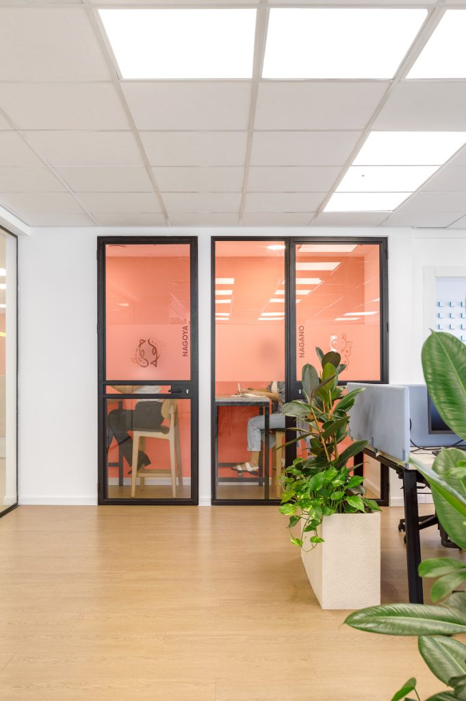 Two peach phone rooms with black frames