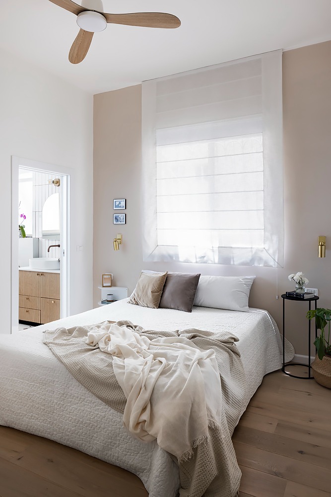 Light bedroom with a wooden ceiling fan