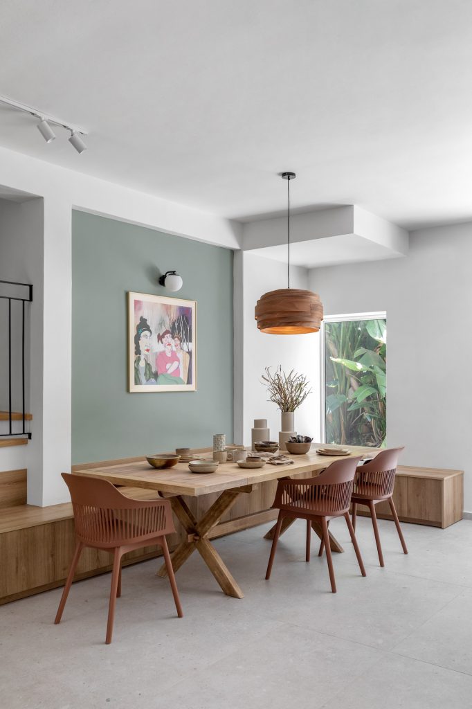 Dining area with a solid wood table and rust chairs