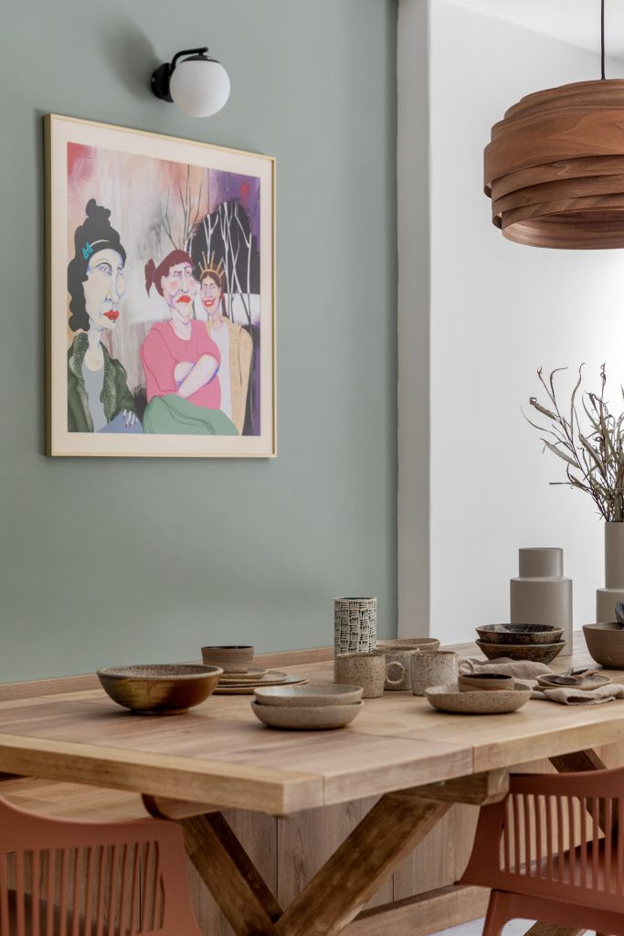 Colourful artwork above the dining table
