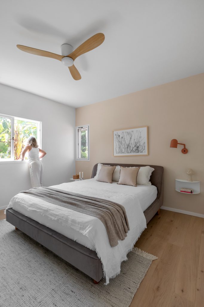 Cream-toned bedroom with a wooden ceiling fan