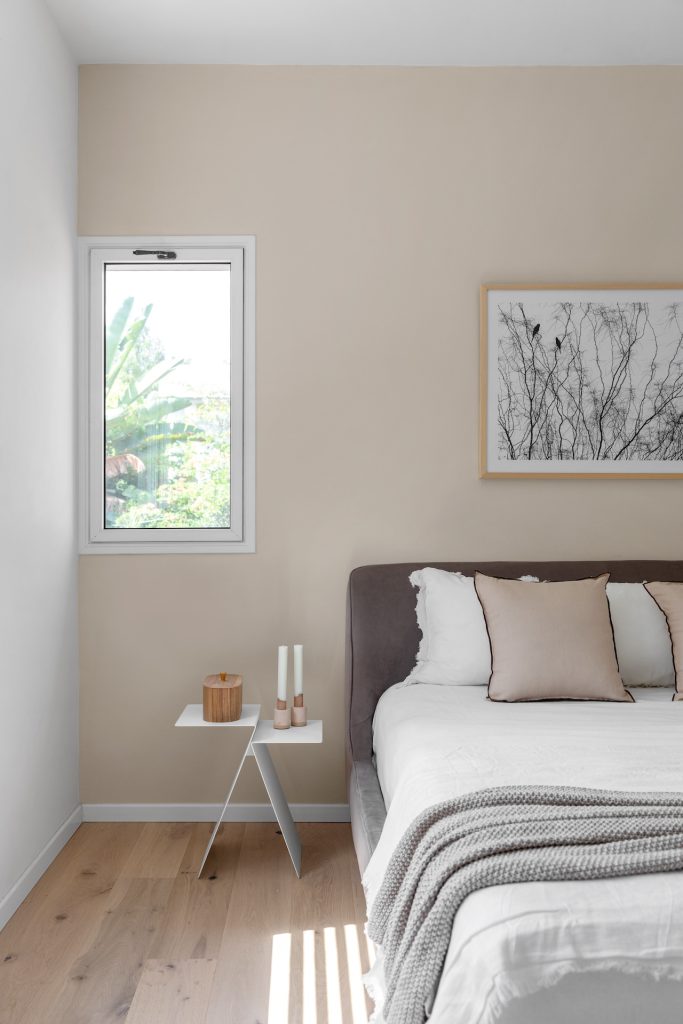 Bedroom with a beige wall and a small garden window