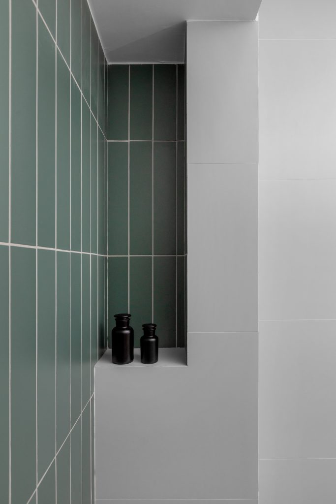 Shower with long green tiles