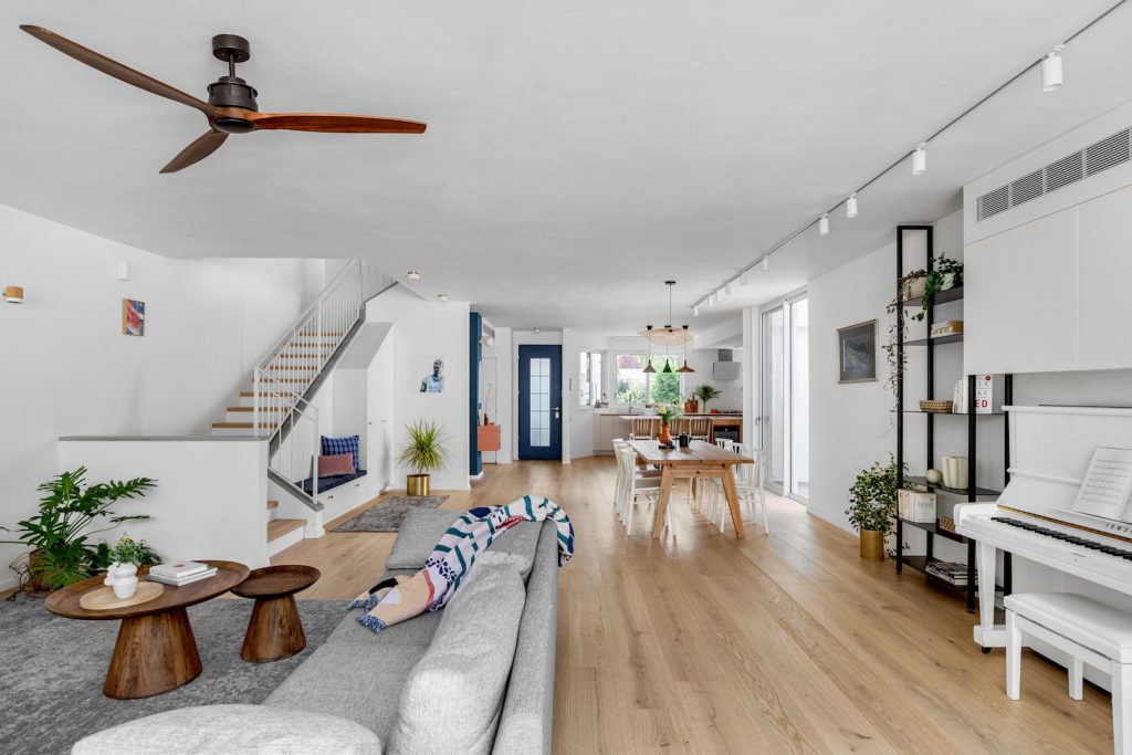 View along the house: living room, stairs and dining area