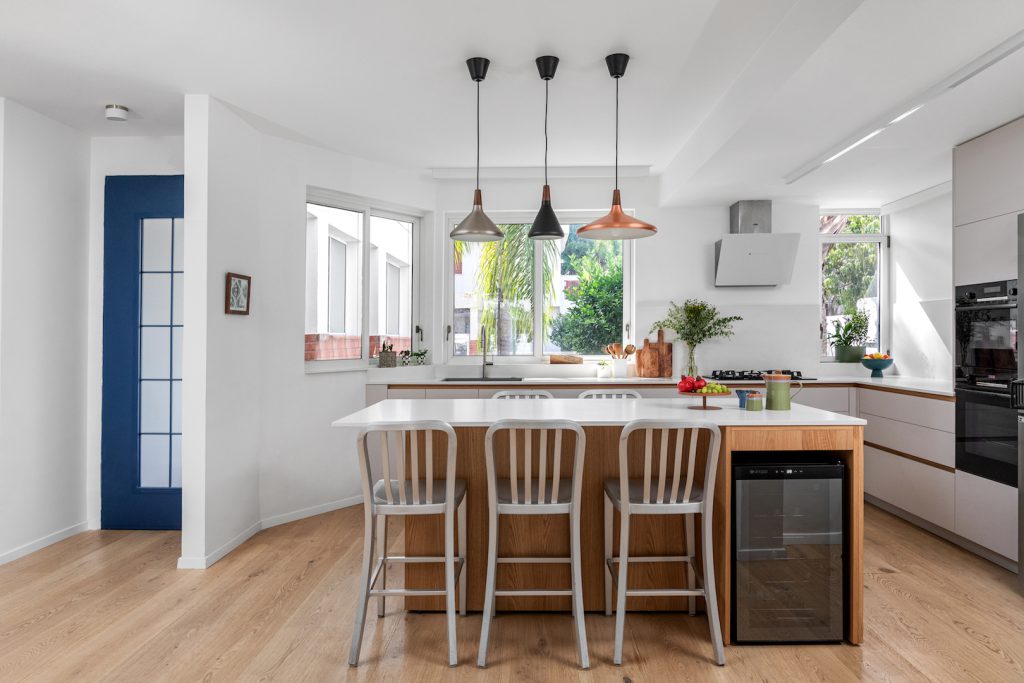Kitchen island with black and copper pendant lights