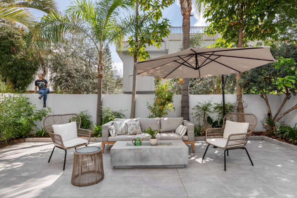 Courtyard with outdoor seating, a parasol and palms