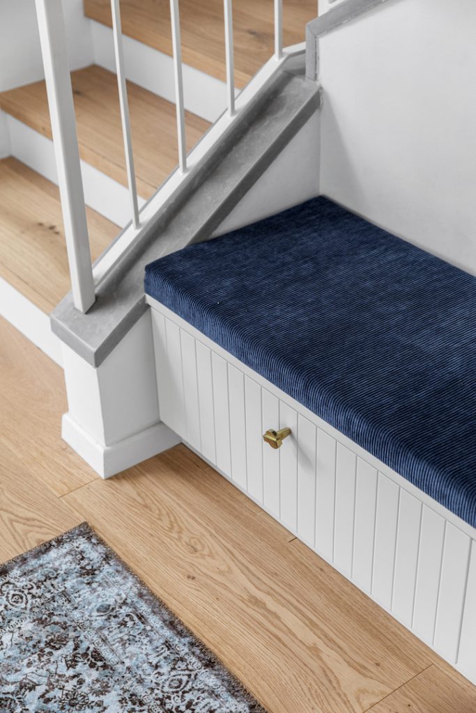 Detail: blue velvet bench under the stairs