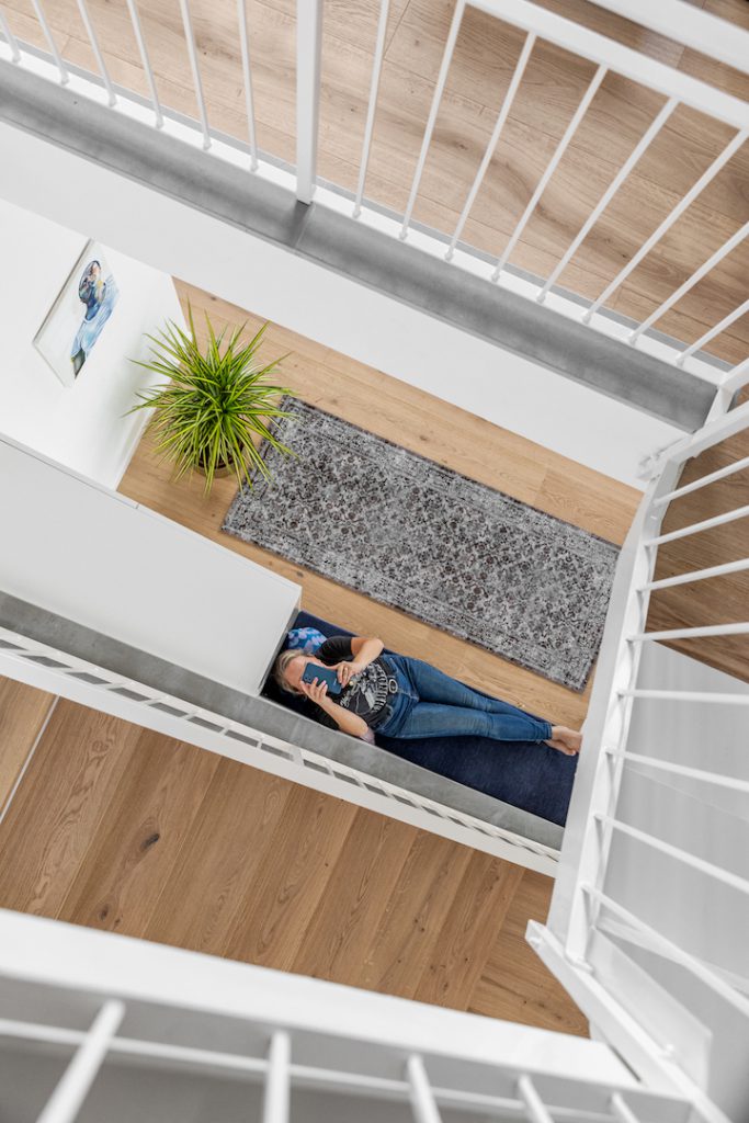 Stairwell seen from above, with a white railing