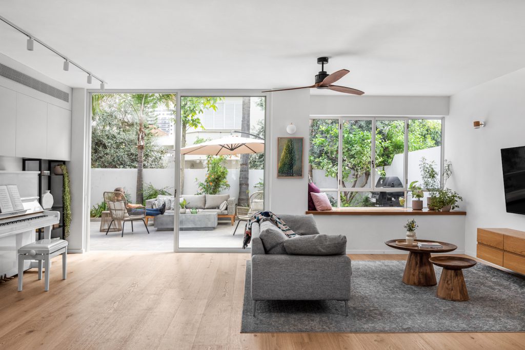 Grey sofa facing wide glass doors to the courtyard