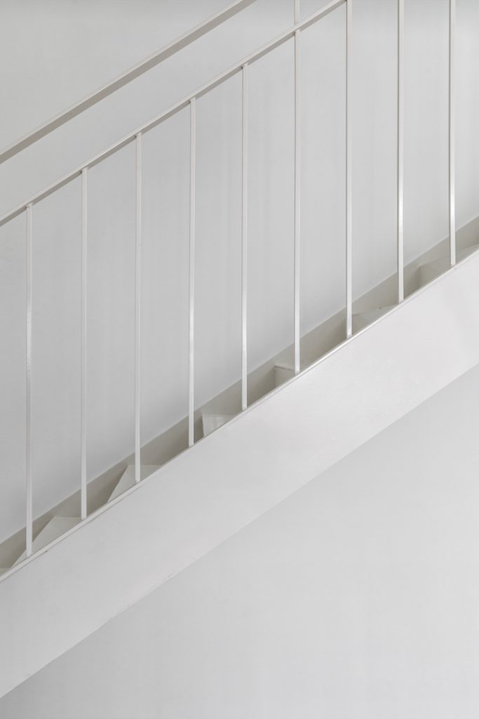 Detail: white vertical-bar stair railing