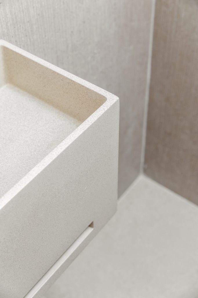 Detail: corner of a white stone basin