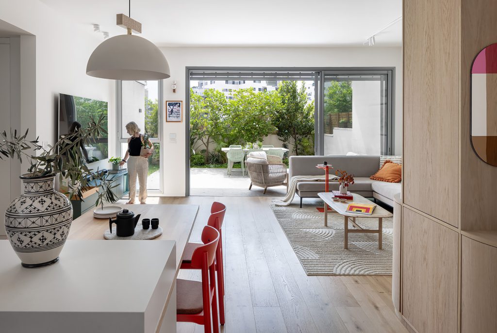 Open space with a rounded wooden column and glass doors to the garden