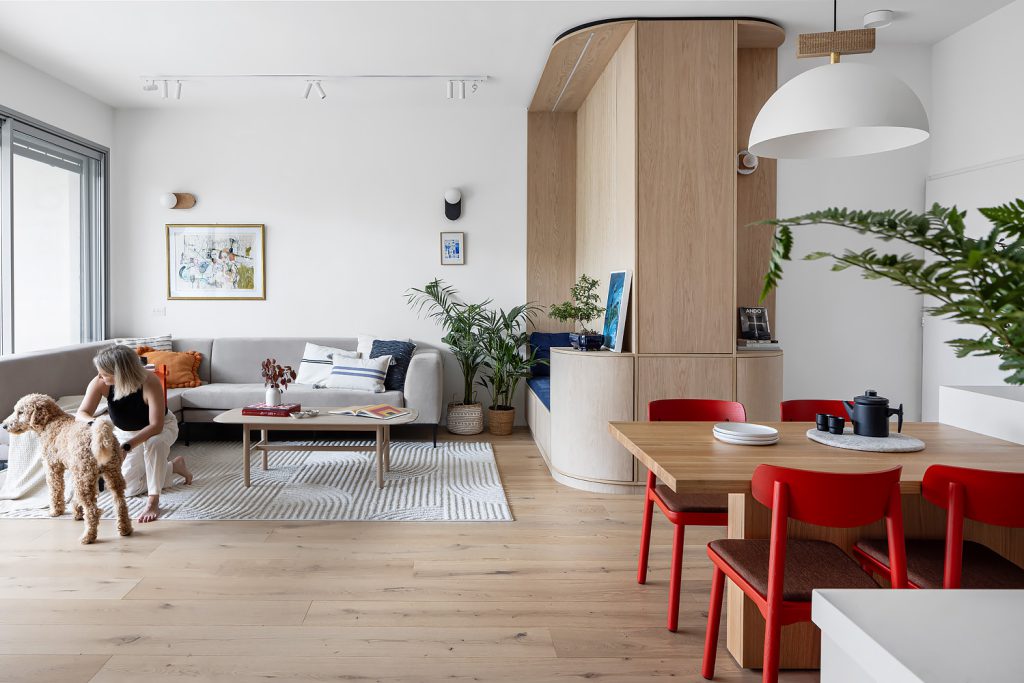 Living and dining area with red chairs and plants