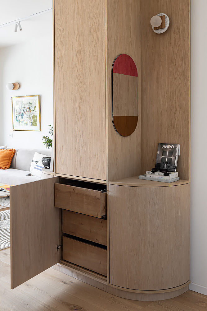 Entrance cabinet open, showing wooden drawers