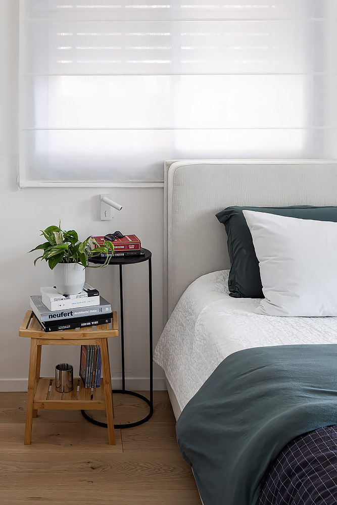 Detail: small wooden nightstand by the bed