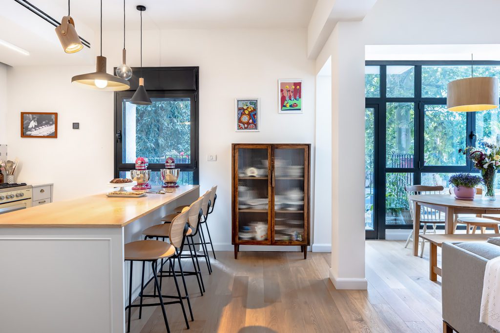 Kitchen with a wooden island, looking to the dining corner window