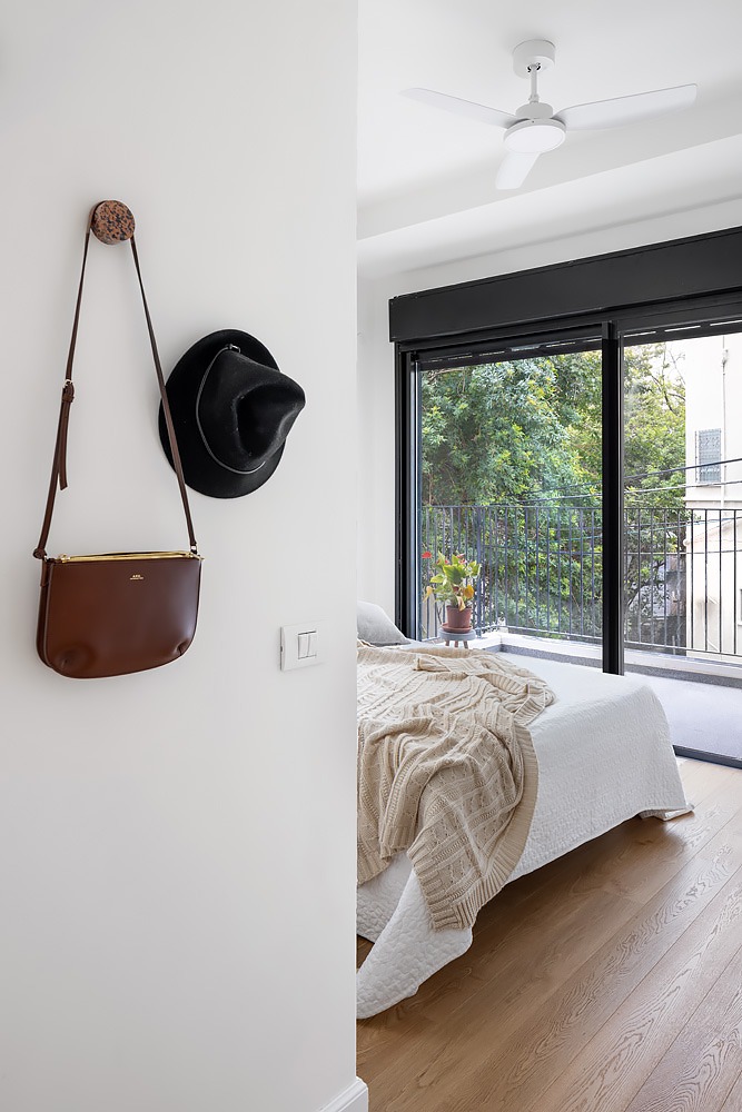 Leather bag hanging by the bedroom doorway