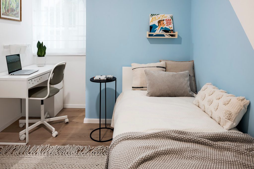 Kids' room with a light blue wall and a white desk