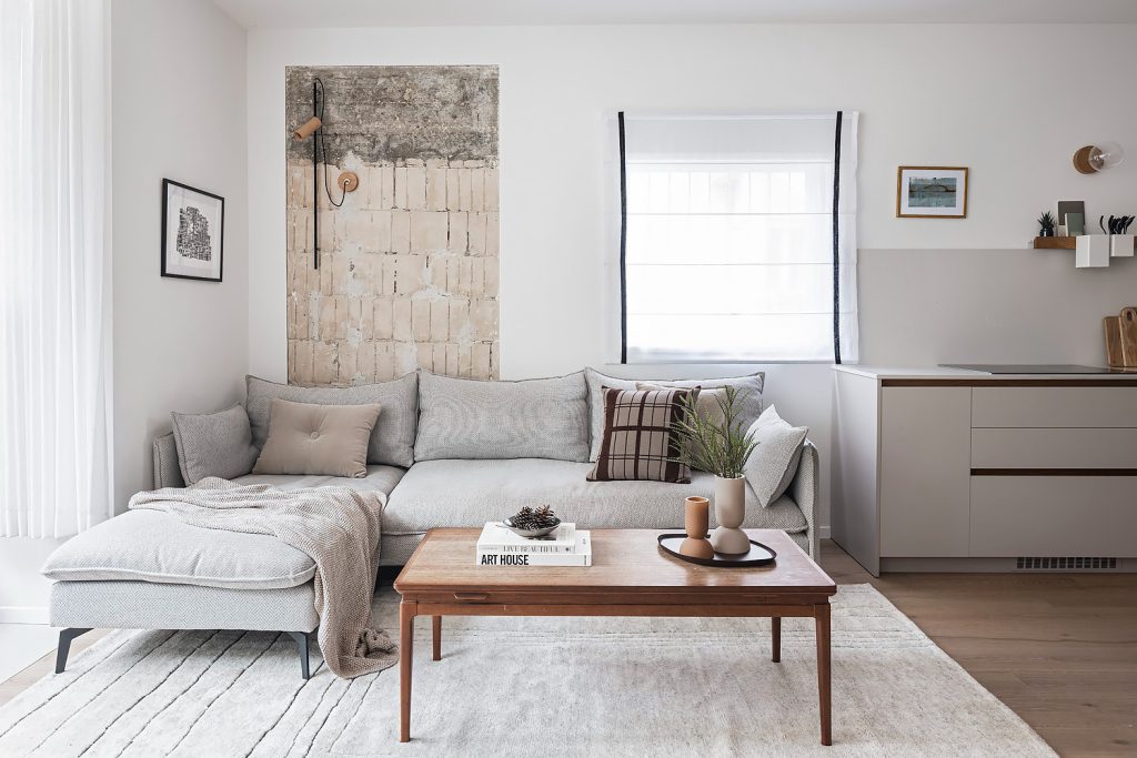 Living room with a grey corner sofa, a wooden coffee table and a large artwork