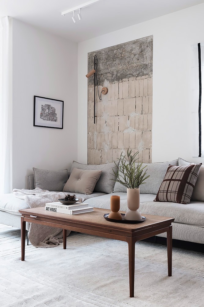 Dark wood coffee table and a grey sofa with check cushions