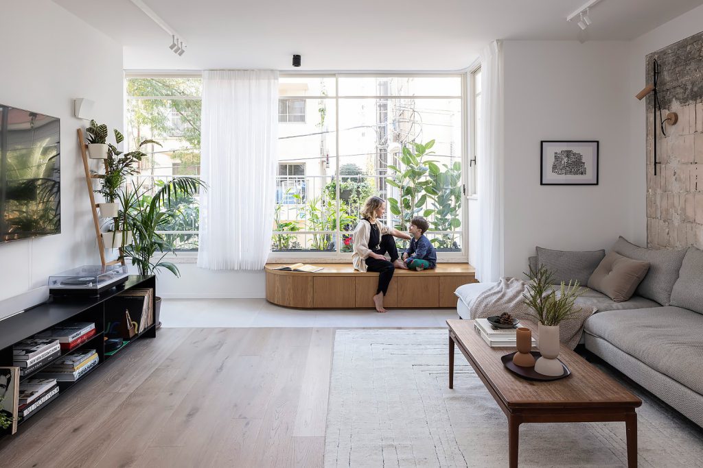 Wooden window bench and a low black TV unit