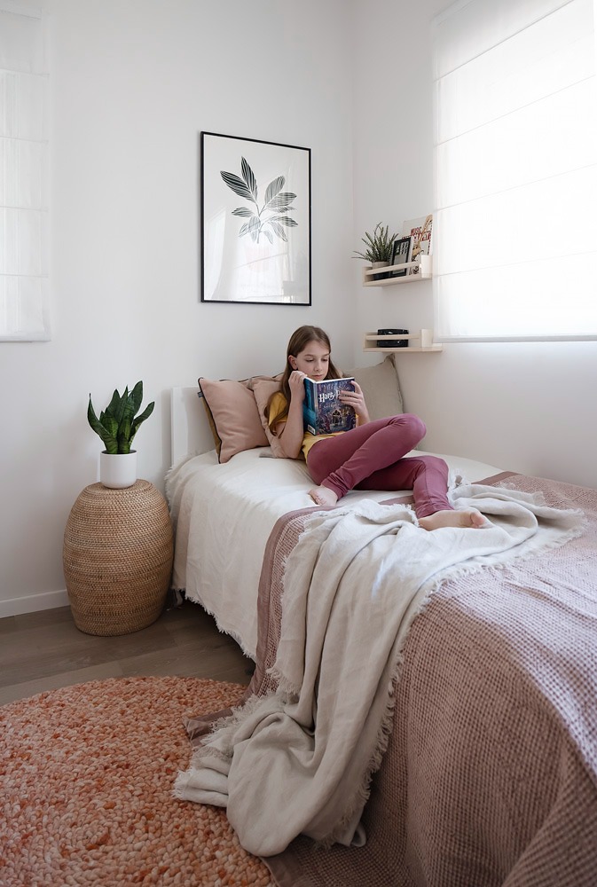 Girl's room with pink bedding and a fluffy rug