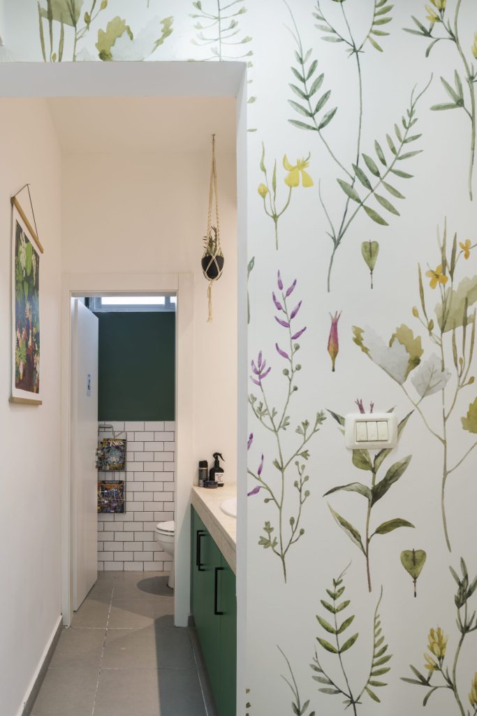 Passage to the toilets with botanical wallpaper