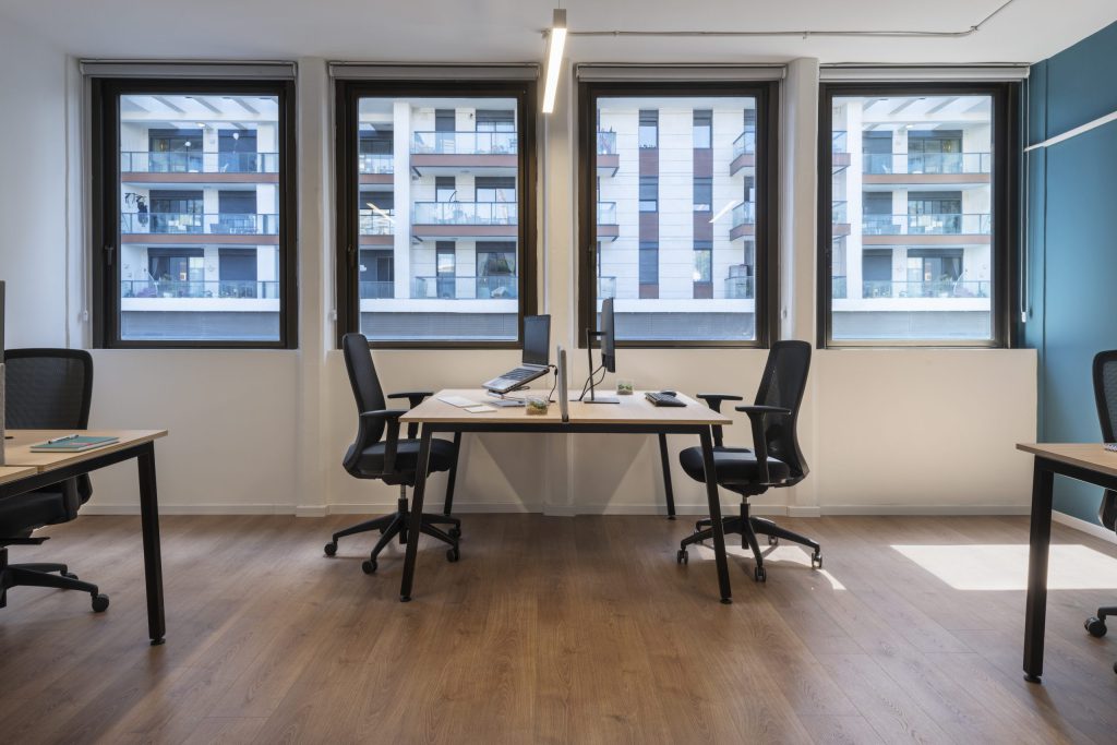 Work room with desks facing three windows