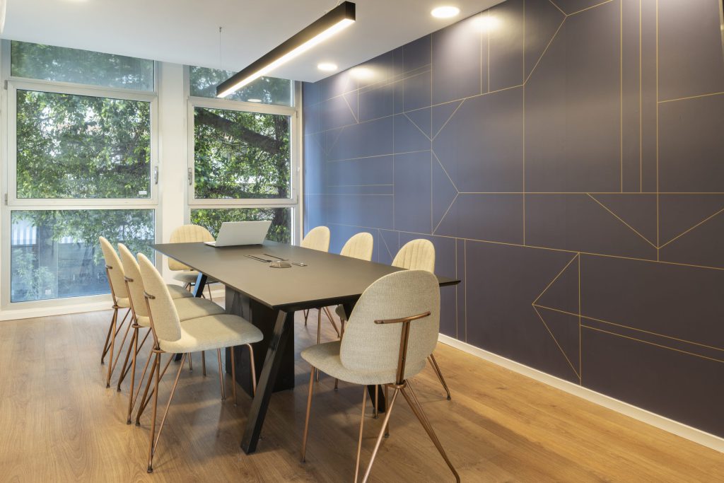 Meeting room with a navy wall and gold lines