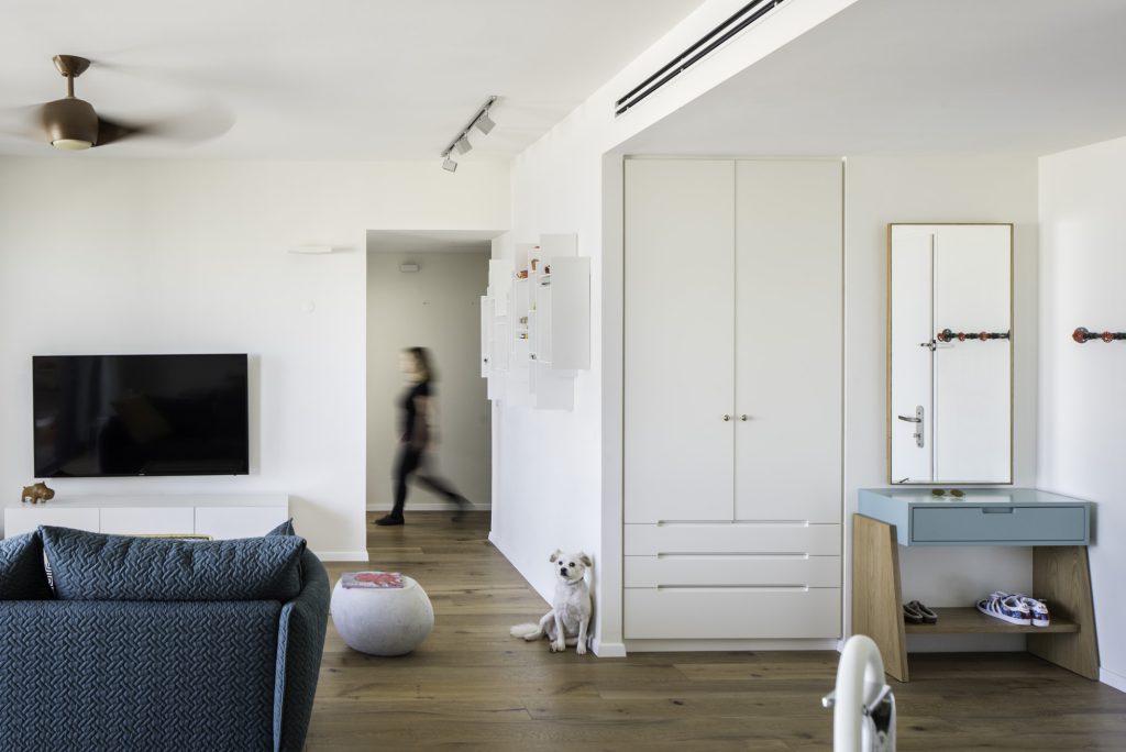 White cabinet wall and a pale blue entrance console