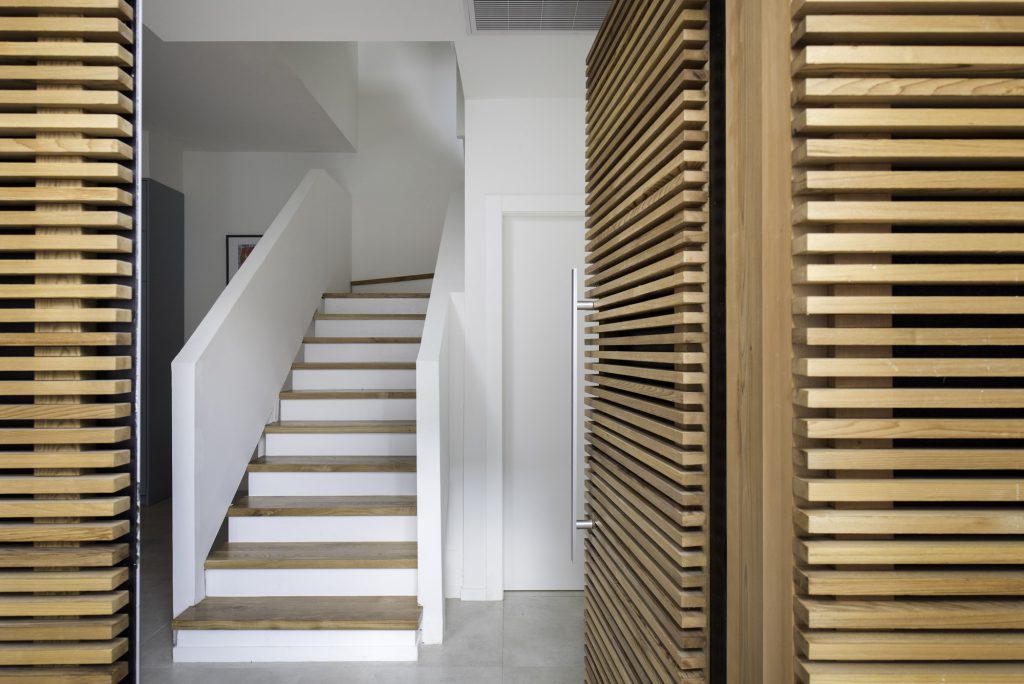 White stairs seen between timber slats