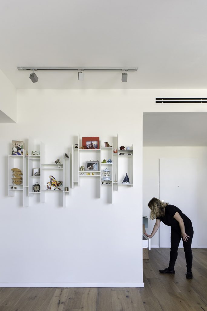 White display shelves on the hallway wall