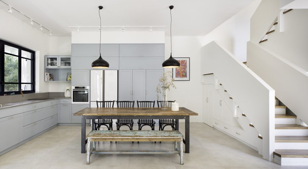 Blue-grey kitchen and dining area beside the stairs