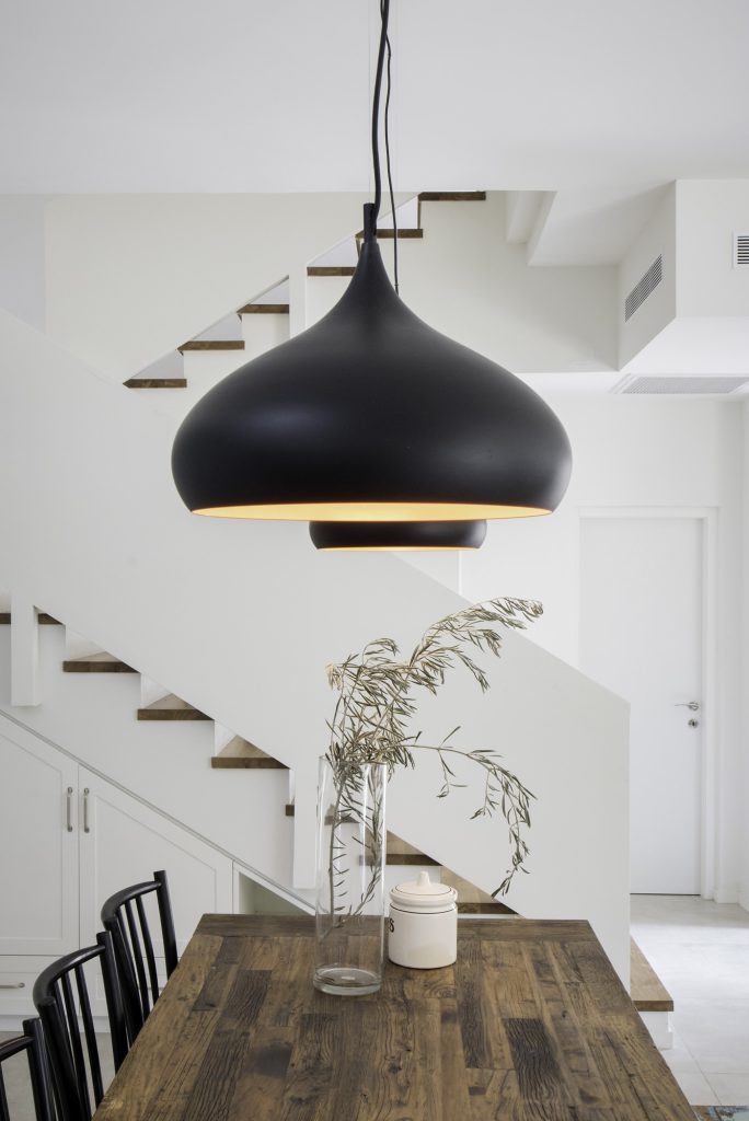 Detail: black pendant above the wooden table