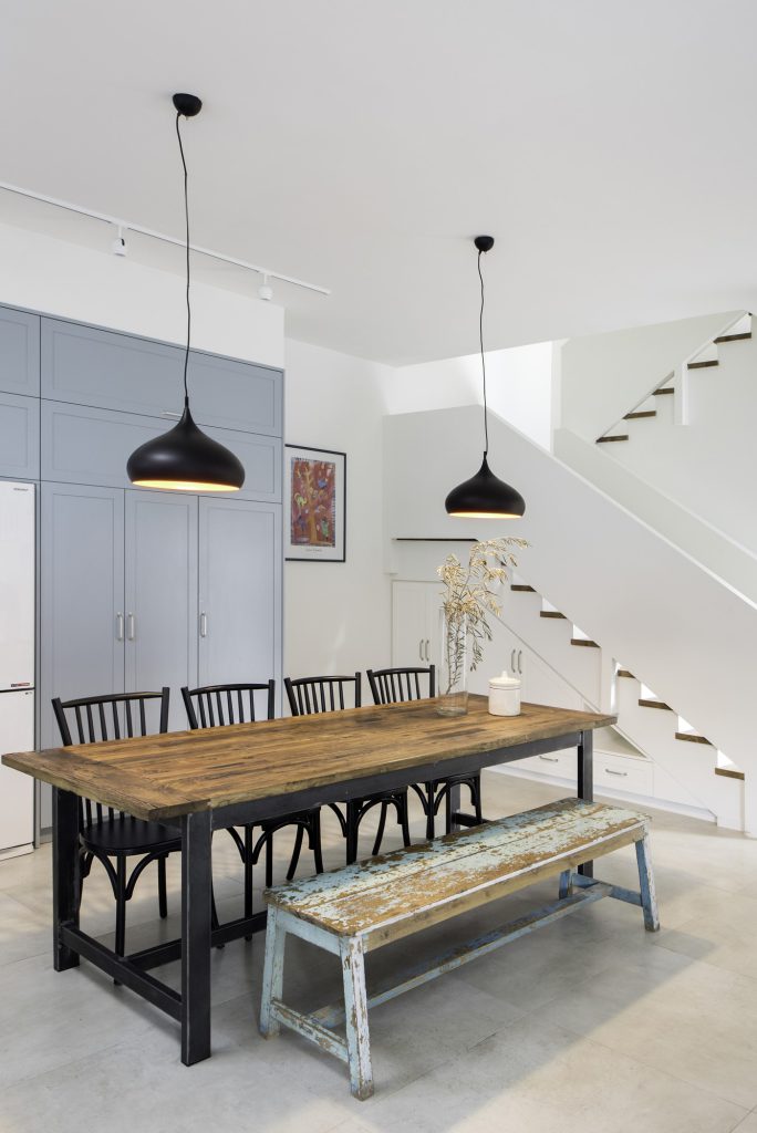 Dining table with a vintage bench by the stairs