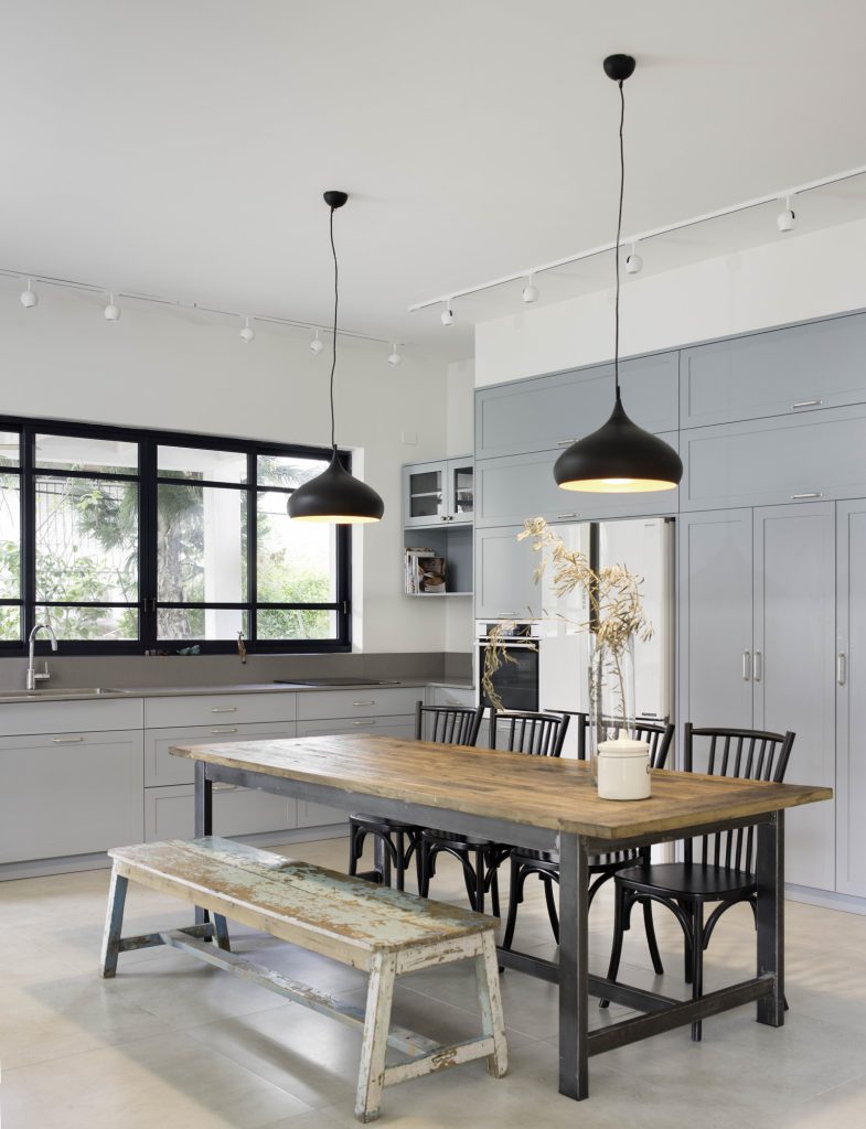 Reclaimed wood dining table and black pendant lights