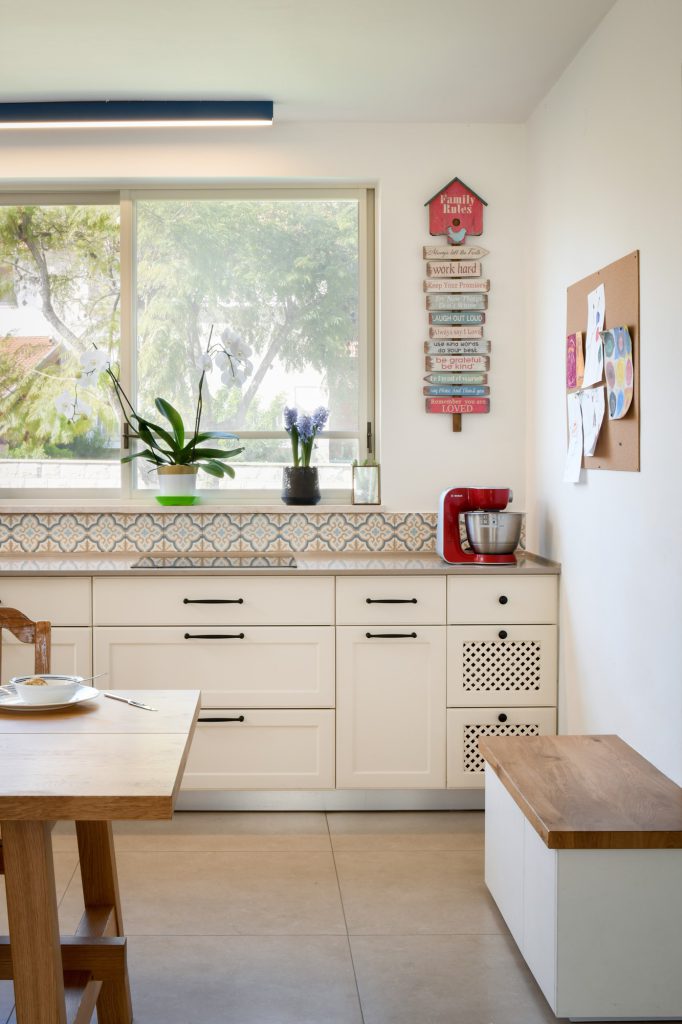 White kitchen below a window with a patterned tile backsplash, town house in Yavne – Chen Shadmi, Shadmi Design
