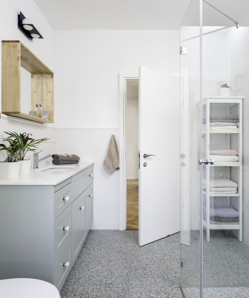 Glass shower and white towel shelves