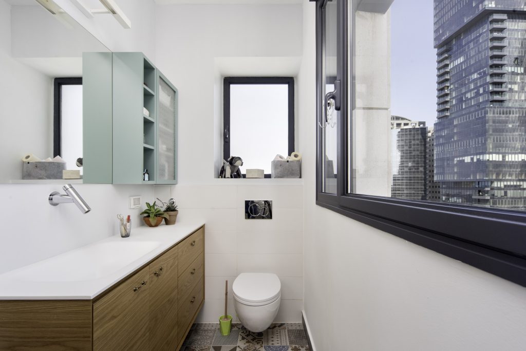 Bathroom with a wooden vanity and a view of the towers