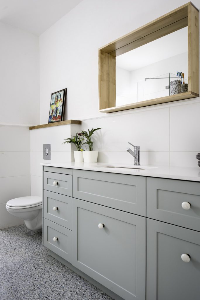 Grey vanity on a terrazzo floor