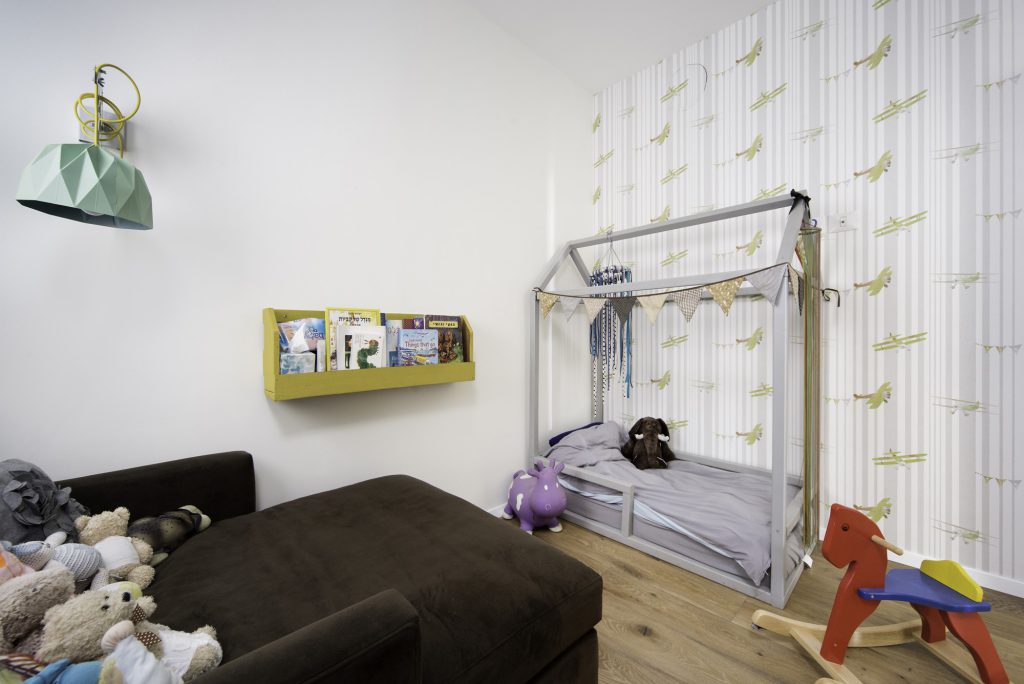 Kids' room with a yellow book ledge and a rocking horse