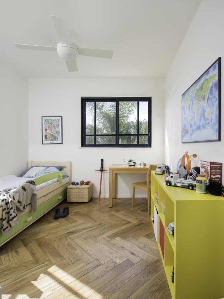 Kids' room with a yellow desk and a herringbone floor