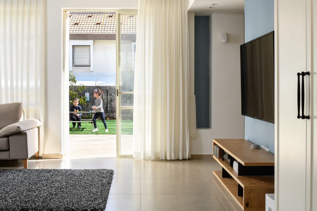 Living room with a glass door open to the garden