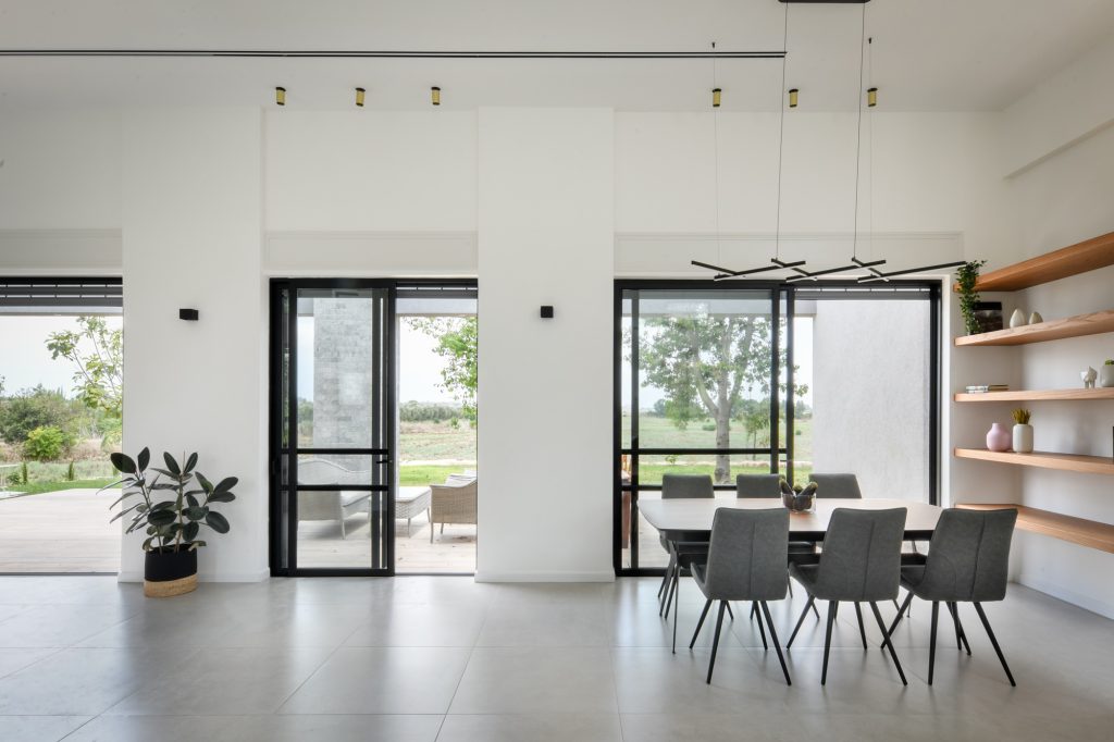 Open space with black-framed glass doors to the yard
