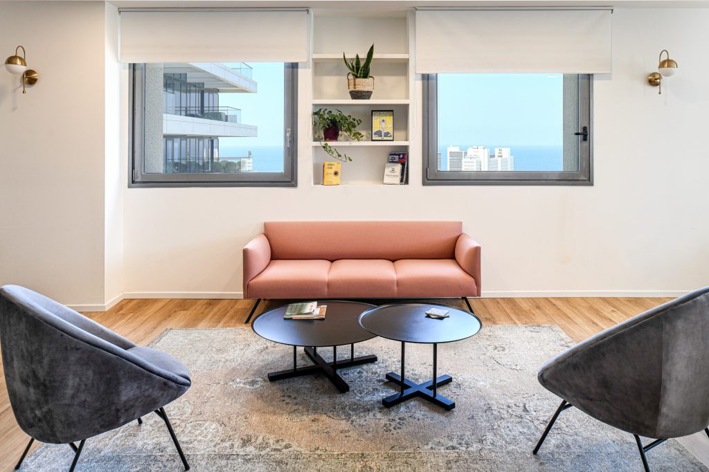 Seating corner with black tables and a sea view