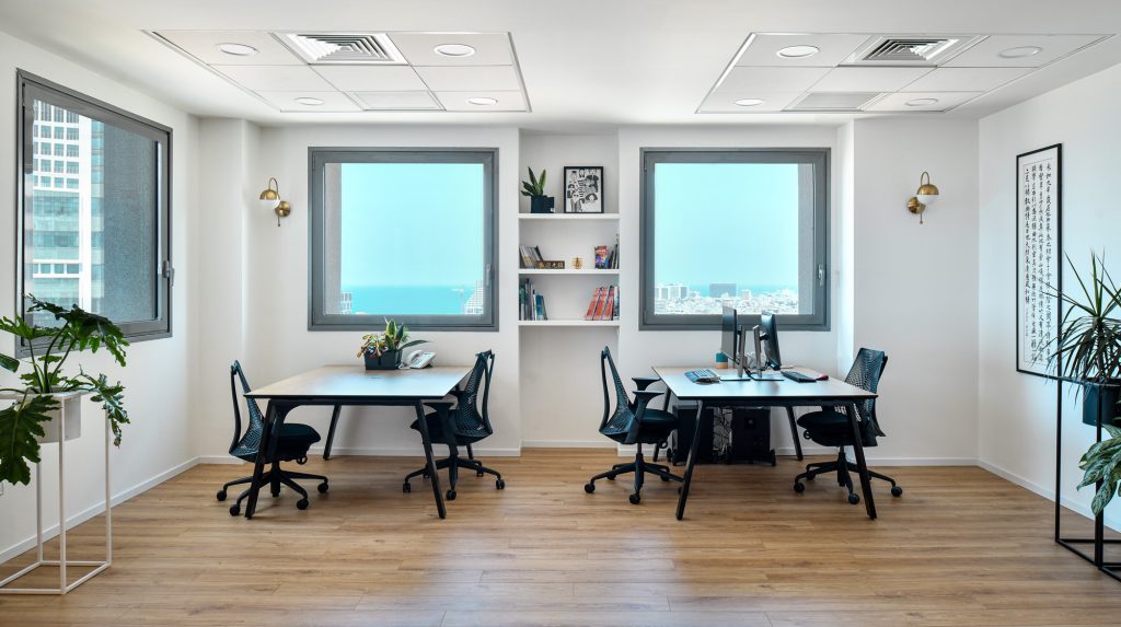 Workstations facing two tower windows