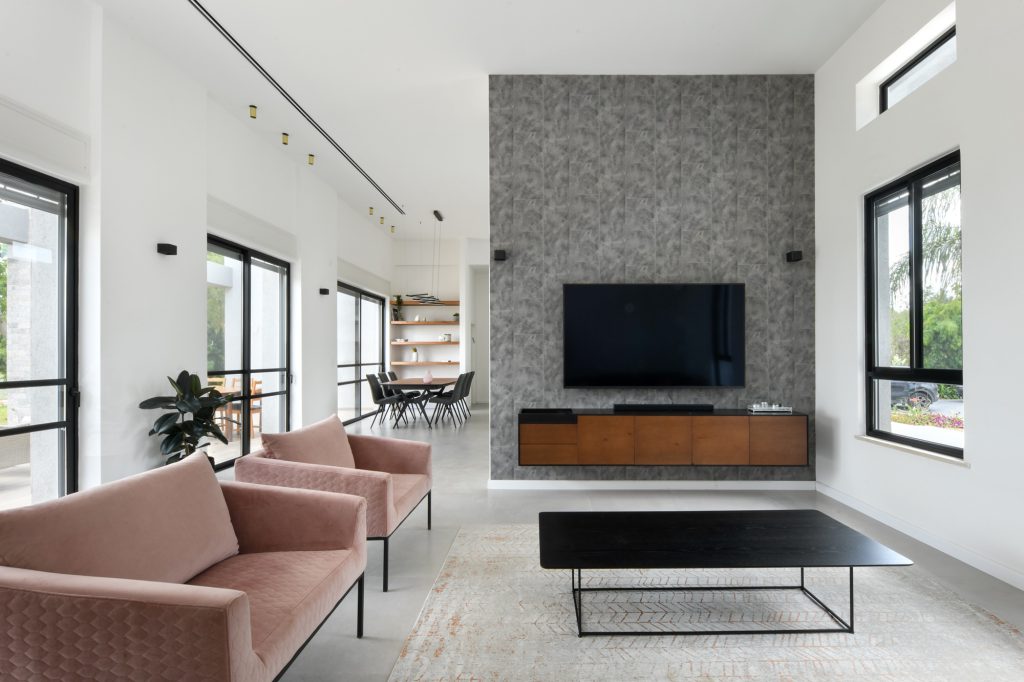 Living room with a black coffee table facing the stone wall