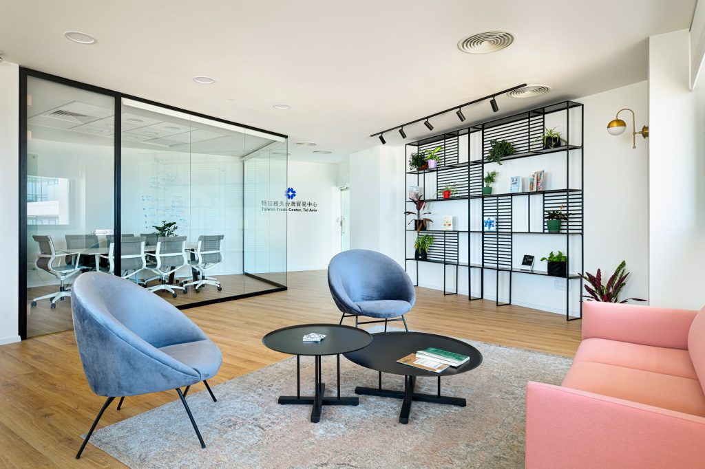 Blue armchairs and black tables in the lobby